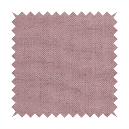 A textured woven fabric in a dusty, muted rose or pale mauve shade.