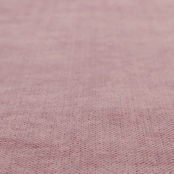 A textured woven fabric in a dusty, muted rose or pale mauve shade.