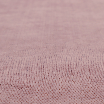 A textured woven fabric in a dusty, muted rose or pale mauve shade.