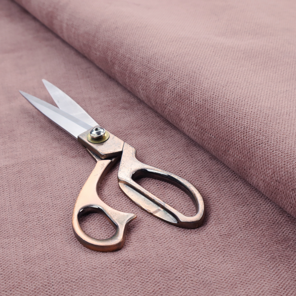 A textured woven fabric in a dusty, muted rose or pale mauve shade.