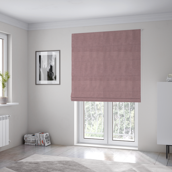 The fabric used to create these Roman blinds is a textured woven fabric in a dusty, muted rose or pale mauve shade.