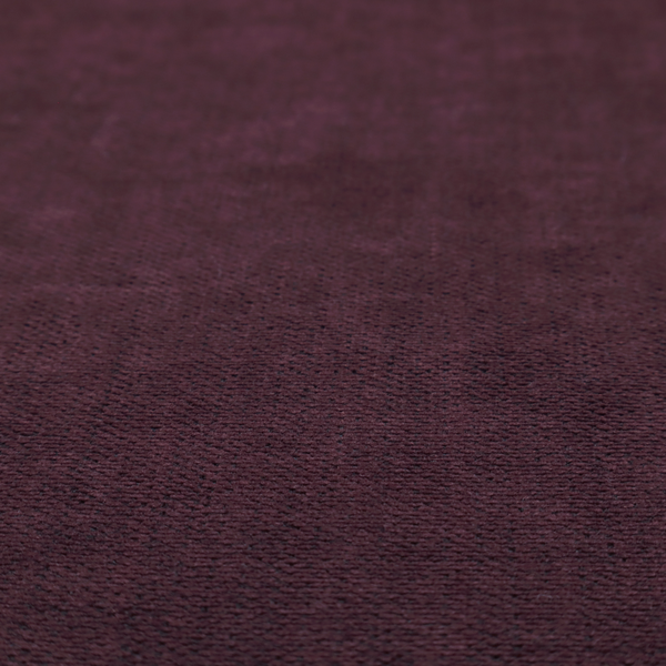 A textured woven fabric in a deep burgundy, plum, or dark aubergine shade.