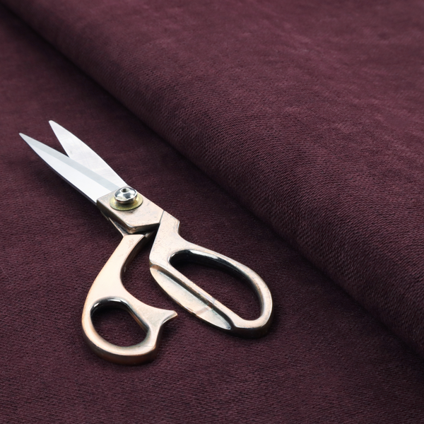 A textured woven fabric in a deep burgundy, plum, or dark aubergine shade.
