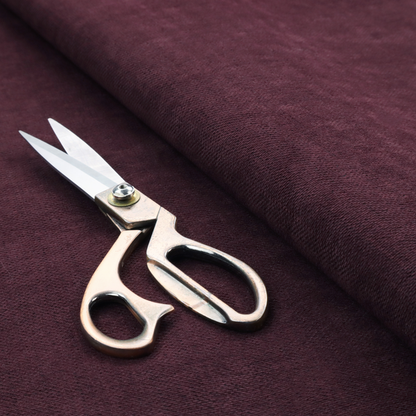 A textured woven fabric in a deep burgundy, plum, or dark aubergine shade.