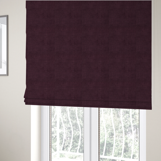 The fabric used to create these Roman blinds is a textured woven fabric in a deep burgundy, plum, or dark aubergine shade.