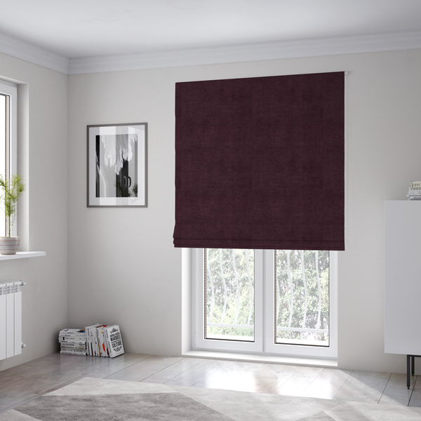 The fabric used to create these Roman blinds is a textured woven fabric in a deep burgundy, plum, or dark aubergine shade.