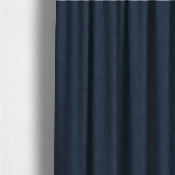 The fabric used to create these made-to-measure curtains is a textured woven fabric in a deep denim or classic navy blue shade.