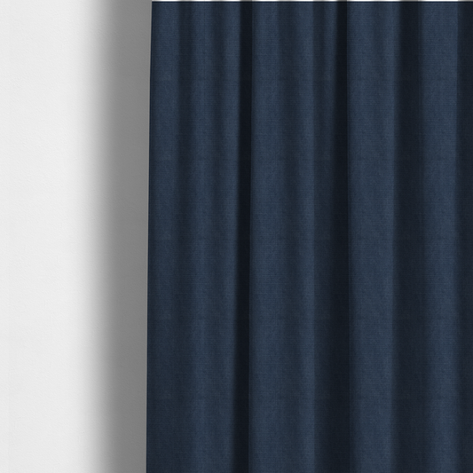 The fabric used to create these made-to-measure curtains is a textured woven fabric in a deep denim or classic navy blue shade.