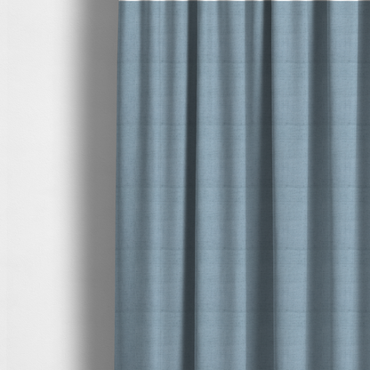 The fabric used to create these made-to-measure curtains is a textured woven fabric in a soft, light powder blue or serene sky blue shade.