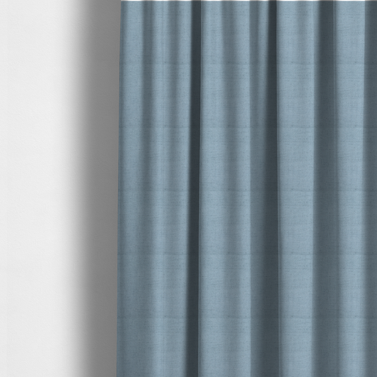 The fabric used to create these made-to-measure curtains is a textured woven fabric in a soft, light powder blue or serene sky blue shade.