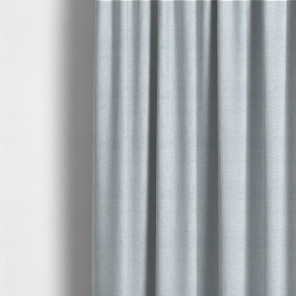 The fabric used to create these made-to-measure curtains is a textured woven fabric in a very pale, icy blue or light mist grey-blue shade.