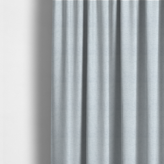 The fabric used to create these made-to-measure curtains is a textured woven fabric in a very pale, icy blue or light mist grey-blue shade.