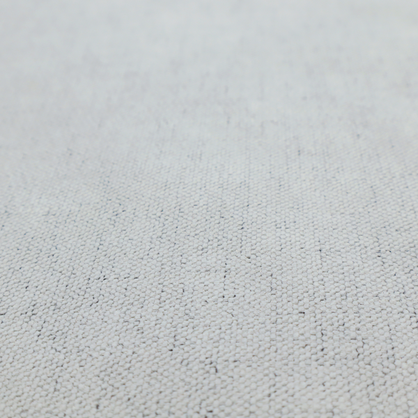 A textured woven fabric in a cool, light grey or soft slate shade.