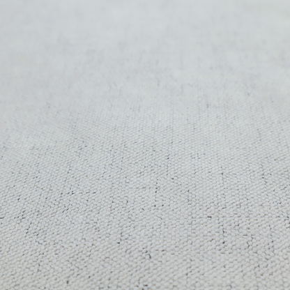 A textured woven fabric in a cool, light grey or soft slate shade.