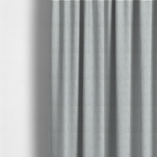 The fabric used to create these made-to-measure curtains is a textured woven fabric in a cool, light grey or soft slate shade.