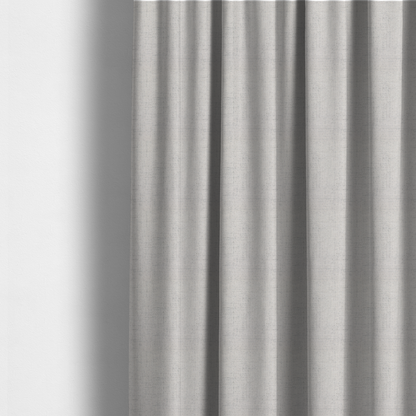 The fabric used to create these made-to-measure curtains is a textured woven fabric in a very light grey or soft ash shade.