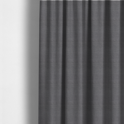 The fabric used to create these made-to-measure curtains is a textured woven fabric in a medium charcoal or slate grey shade.