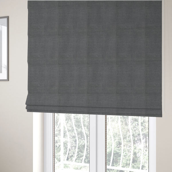 The fabric used to create these Roman blinds is a textured woven fabric in a medium charcoal or slate grey shade.