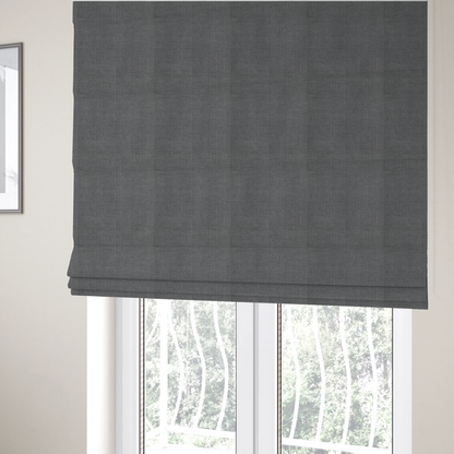 The fabric used to create these Roman blinds is a textured woven fabric in a medium charcoal or slate grey shade.