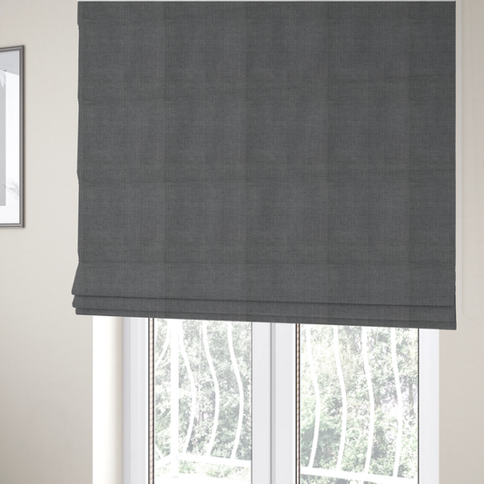 The fabric used to create these Roman blinds is a textured woven fabric in a medium charcoal or slate grey shade.