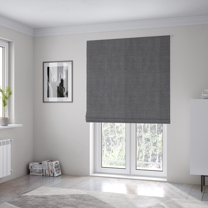 The fabric used to create these Roman blinds is a textured woven fabric in a medium charcoal or slate grey shade.