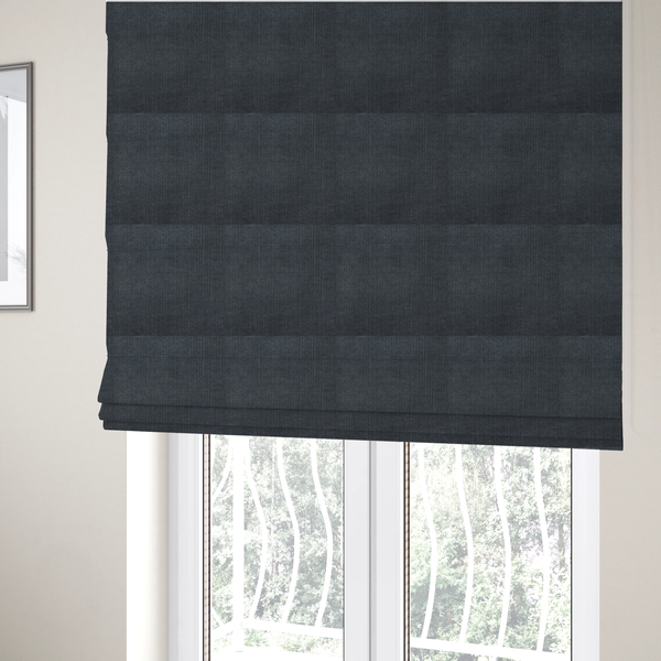 The fabric used to create these Roman blinds is a textured woven fabric in a deep slate or dark charcoal grey shade.