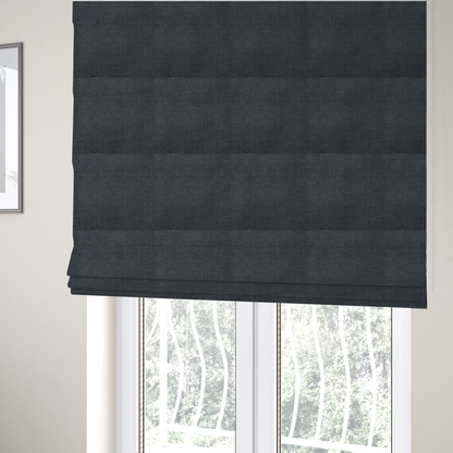 The fabric used to create these Roman blinds is a textured woven fabric in a deep slate or dark charcoal grey shade.