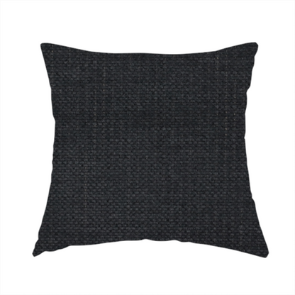 The fabric used to create this handmade cushion is a textured woven fabric in a near-black or extremely dark charcoal shade.