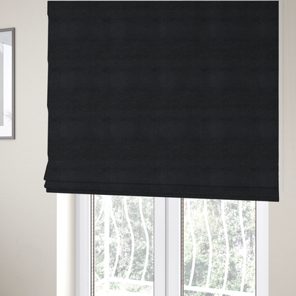 The fabric used to create these Roman blinds is a textured woven fabric in a near-black or extremely dark charcoal shade.