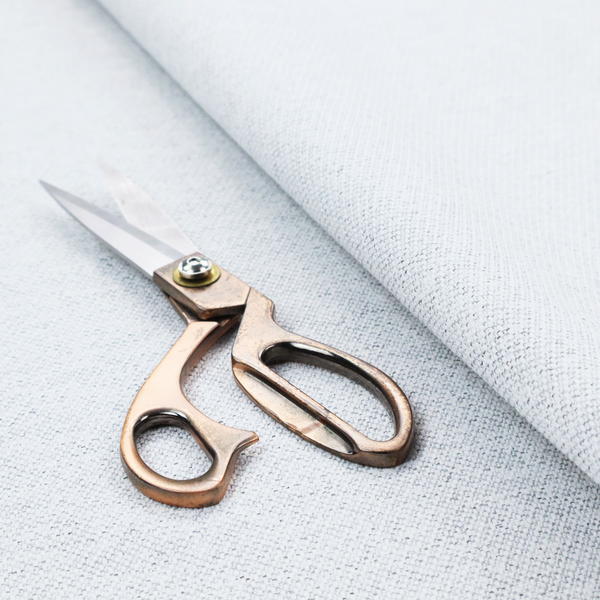 A textured silver woven fabric with a subtle metallic sheen.