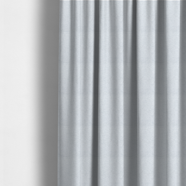 The fabric used to create this made-to-measure curtains is a textured silver woven fabric with a subtle metallic sheen.