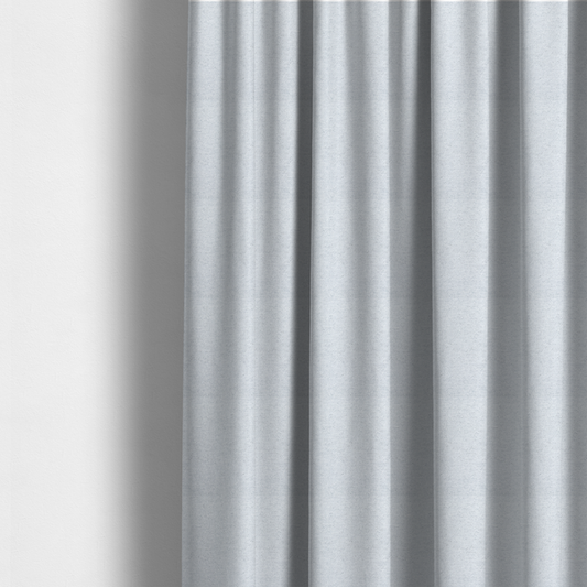 The fabric used to create this made-to-measure curtains is a textured silver woven fabric with a subtle metallic sheen.