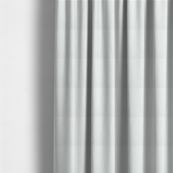 The fabric used to create these made-to-measure curtains is a white woven upholstery fabric with a subtle, textured grain.