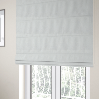 The fabric used to create these Roman blinds is a white woven upholstery fabric with a subtle, textured grain.