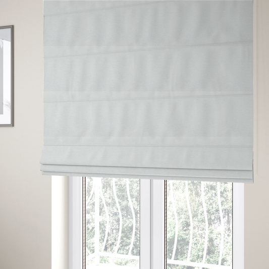 The fabric used to create these Roman blinds is a white woven upholstery fabric with a subtle, textured grain.