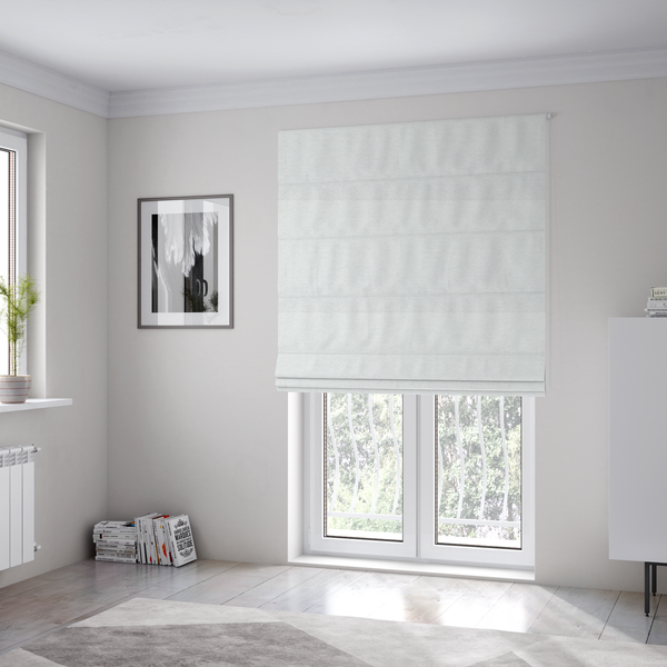 The fabric used to create these Roman blinds is a white woven upholstery fabric with a subtle, textured grain.