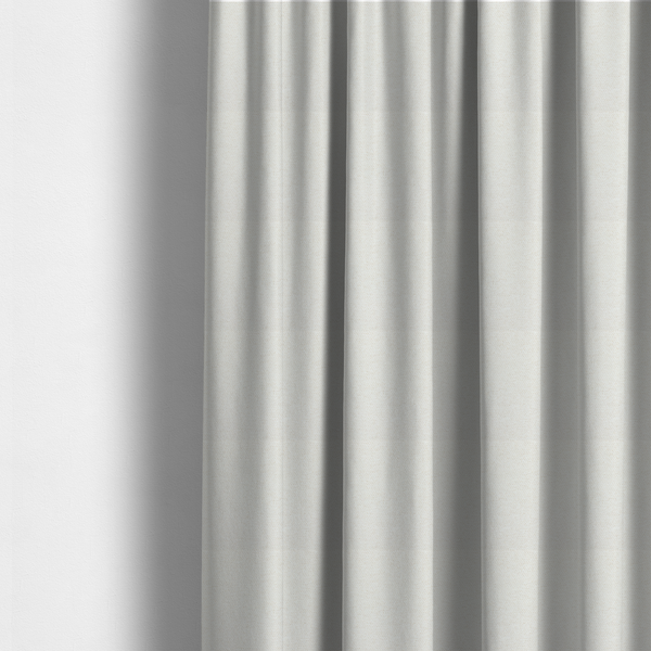 The fabric used to create these made-to-measure curtains is a cream or ivory woven upholstery fabric with a fine, pebble-like texture.