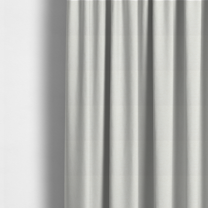 The fabric used to create these made-to-measure curtains is a cream or ivory woven upholstery fabric with a fine, pebble-like texture.