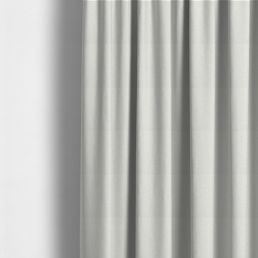 The fabric used to create these made-to-measure curtains is a cream or ivory woven upholstery fabric with a fine, pebble-like texture.