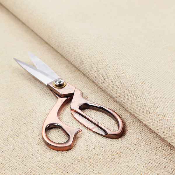 A light beige woven upholstery fabric with a dense, sandy texture.