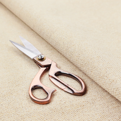 A light beige woven upholstery fabric with a dense, sandy texture.