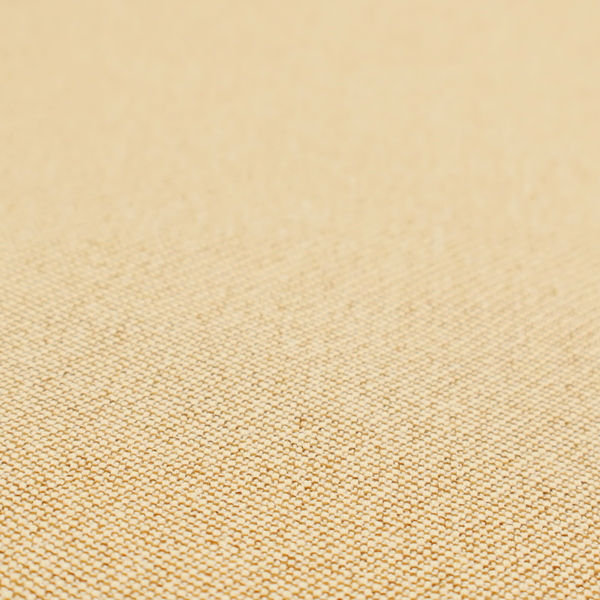 A sandy beige textile featuring a tight diagonal twill weave. The fabric is composed of interlaced cream and light tan threads, creating a fine, granular texture with a matte finish.