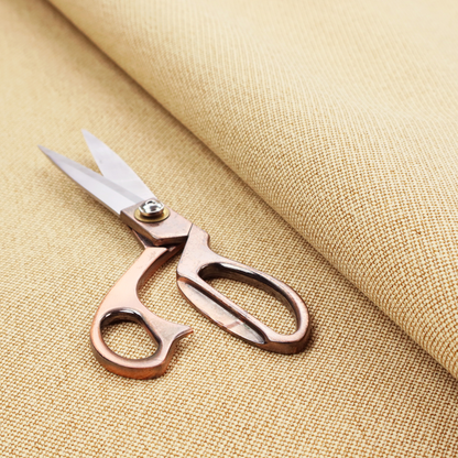 A sandy beige textile featuring a tight diagonal twill weave. The fabric is composed of interlaced cream and light tan threads, creating a fine, granular texture with a matte finish.