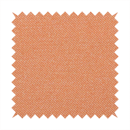 A vibrant apricot or orange textile with a tight diagonal twill weave. The fabric is woven with a primary saturated orange thread interspersed with fine white or cream yarns, creating a bright, textured surface with a subtle "salt and pepper" effect.