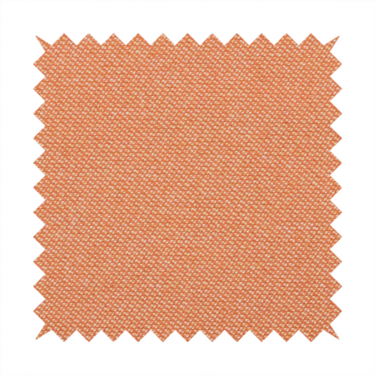 A vibrant apricot or orange textile with a tight diagonal twill weave. The fabric is woven with a primary saturated orange thread interspersed with fine white or cream yarns, creating a bright, textured surface with a subtle "salt and pepper" effect.