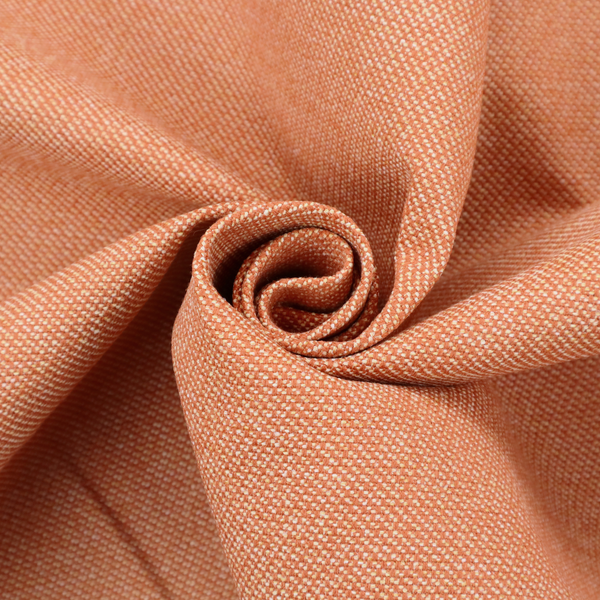 A vibrant apricot or orange textile with a tight diagonal twill weave. The fabric is woven with a primary saturated orange thread interspersed with fine white or cream yarns, creating a bright, textured surface with a subtle "salt and pepper" effect.