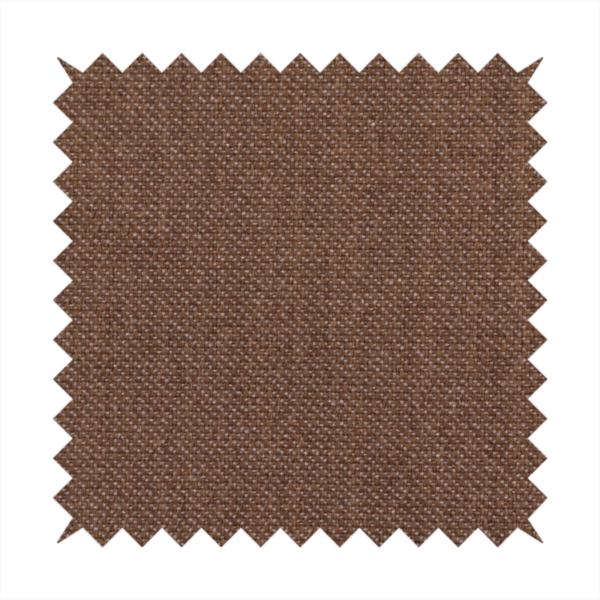 a dark chocolate or mocha brown textile with a tight diagonal twill weave. The fabric is woven with a deep brown base interspersed with fine, lighter threads that create a subtle shimmering or "salt and pepper" effect across the surface.