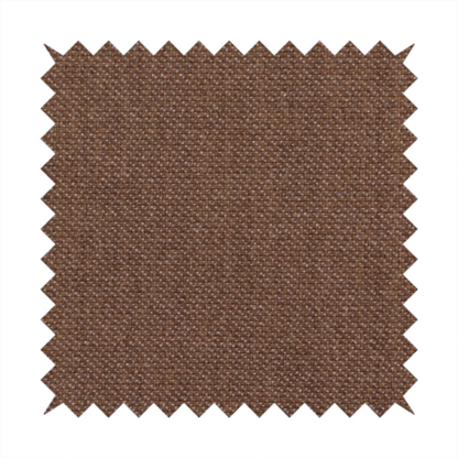 a dark chocolate or mocha brown textile with a tight diagonal twill weave. The fabric is woven with a deep brown base interspersed with fine, lighter threads that create a subtle shimmering or "salt and pepper" effect across the surface.