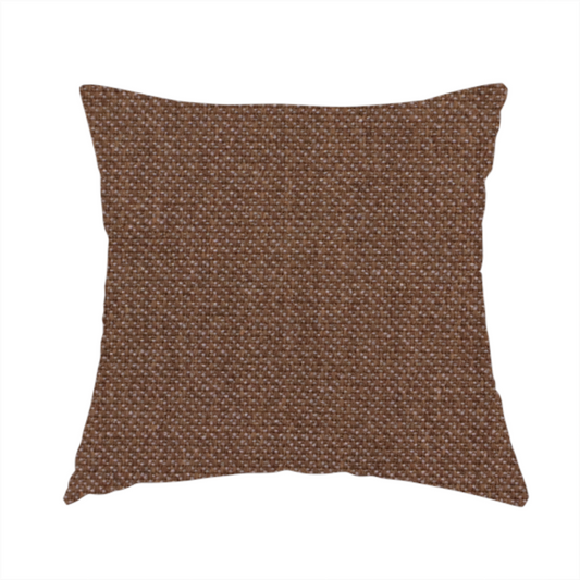 The fabric used to create this handmade cushion is a dark chocolate or mocha brown textile with a tight diagonal twill weave. The fabric is woven with a deep brown base interspersed with fine, lighter threads that create a subtle shimmering or "salt and pepper" effect across the surface.