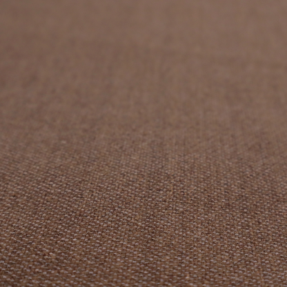 a dark chocolate or mocha brown textile with a tight diagonal twill weave. The fabric is woven with a deep brown base interspersed with fine, lighter threads that create a subtle shimmering or "salt and pepper" effect across the surface.